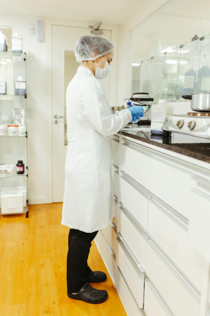 A female scientist in a lab coat performs a scientific experiment in a modern laboratory setting.